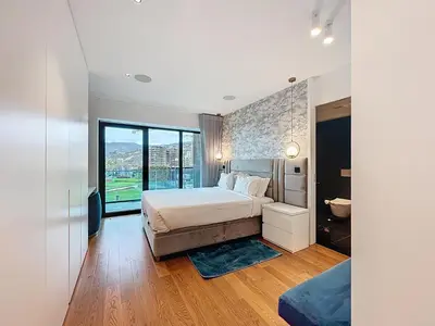 a bedroom with a large bed and a large window at Varinos Seaview Apartment in Funchal