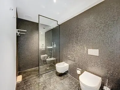a bathroom with a toilet and a sink and a shower at Varinos Seaview Apartment in Funchal