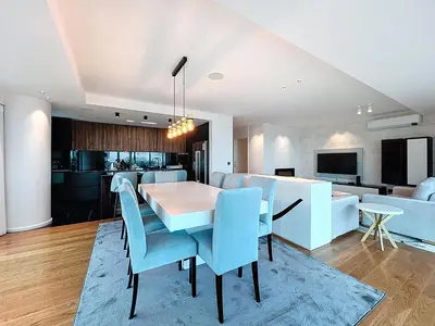 a dining room and living room with a table and chairs at Varinos Seaview Apartment in Funchal