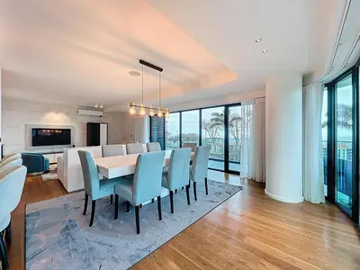 a dining room with a table and chairs at Varinos Seaview Apartment in Funchal