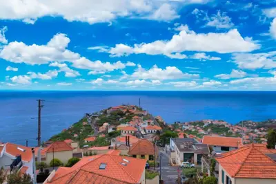 a view of a town with the ocean in the background at Villa Branca in Ponta do Sol