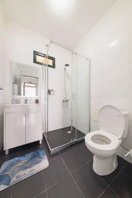 a bathroom with a toilet and a glass shower at Casa do Vale by Mth in Ribeira Brava