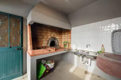 a small kitchen with a sink and a stove at Casa do Vale by Mth in Ribeira Brava
