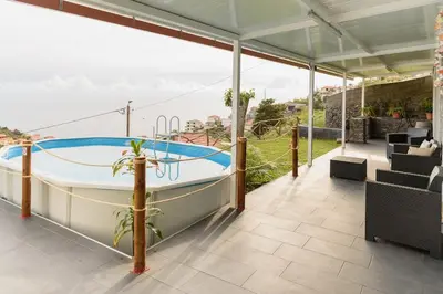 a hot tub on the patio of a house at Casa do Vale by Mth in Ribeira Brava