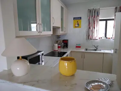 a kitchen with a yellow lamp on a counter at Magnifique appartement face à l'océan, Casa Waterside in Luz