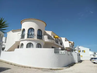 a white house with a white wall and a fence at Magnifique appartement face à l'océan, Casa Waterside in Luz