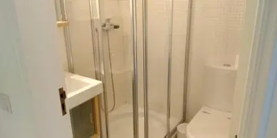 a bathroom with a shower and a toilet and a sink at Magnifique appartement face à l'océan, Casa Waterside in Luz
