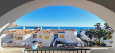 a view of a house with the ocean in the background at Magnifique appartement face à l'océan, Casa Waterside in Luz