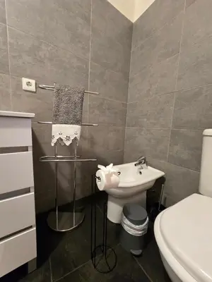 a bathroom with a sink and a toilet at Paz House in Caniço