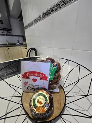 a table with a box of donuts and a bag of chocolate at Paz House in Caniço