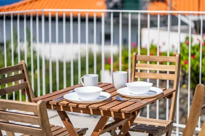 a view of a town with houses and the ocean at Social Lodge Galinho House - Sea View - Calheta in Estreito da Calheta