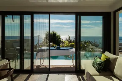 a villa with a swimming pool and the ocean at Vila Ladeira dos Zimbreiros - 3 bedroom, Jacuzzi, gym, AC, Pool with optional heated water in Paul do Mar