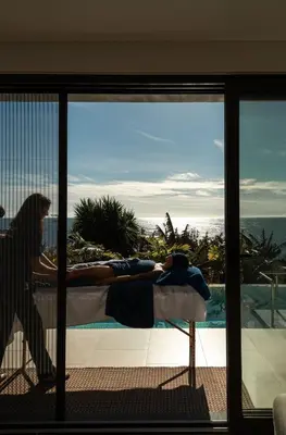 a desk with a computer and a green wall at Vila Ladeira dos Zimbreiros - 3 bedroom, Jacuzzi, gym, AC, Pool with optional heated water in Paul do Mar