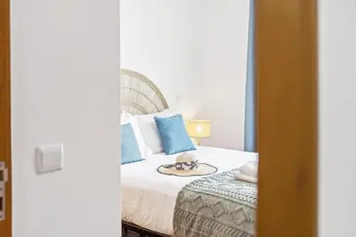 a bedroom with a bed with a hat on it at Locally by Homie in Funchal