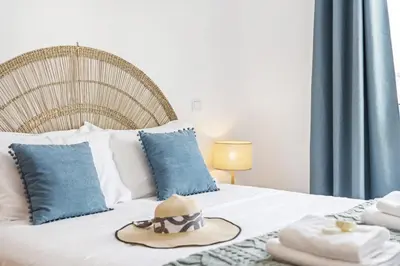 a bedroom with a bed with a hat and towels at Locally by Homie in Funchal