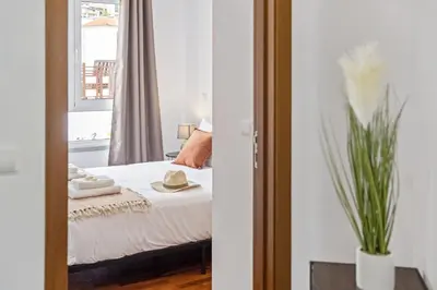 a bedroom with a bed and a window at Locally by Homie in Funchal