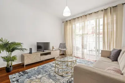 a living room with a couch and a tv at Locally by Homie in Funchal