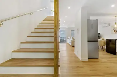 a staircase in a home with white walls and wood floors at Casa Belavista in Gaula