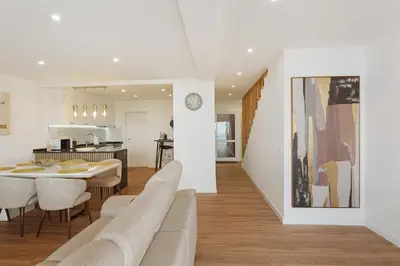 a living room and kitchen with a table and chairs at Casa Belavista in Gaula