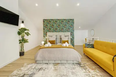 a bedroom with a bed and a yellow couch at Casa Belavista in Gaula