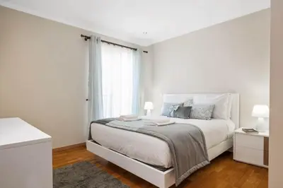 a white bedroom with a bed and a window at Penthouse Prestige by Homie in Funchal