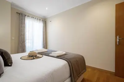a bedroom with a bed with towels and a window at Penthouse Prestige by Homie in Funchal