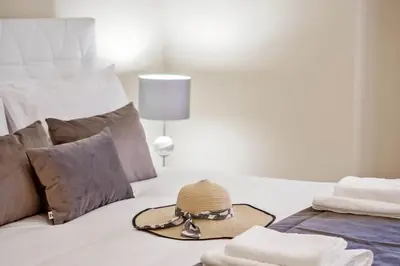 a bedroom with a bed with a hat on it at Penthouse Prestige by Homie in Funchal