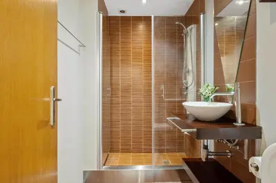 a bathroom with a sink and a glass shower at Penthouse Prestige by Homie in Funchal