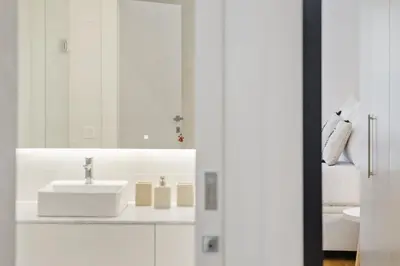 a white bathroom with a sink and a mirror at Acquas Bliss by Homie in Funchal