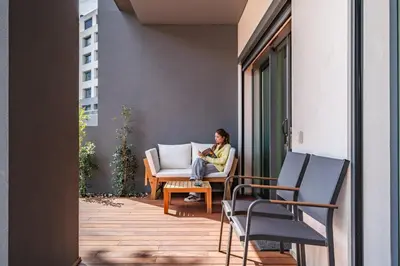 a woman sitting on a chair on a balcony at Acquas Bliss by Homie in Funchal