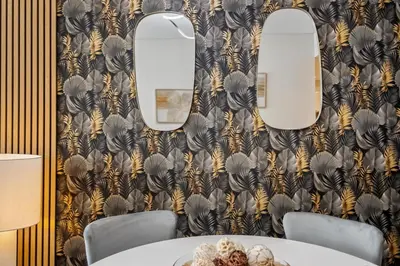 a dining room with a table and two mirrors at Oceans Glow by Homie in Funchal