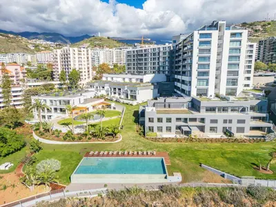 an aerial view of a city with a swimming pool and buildings at Oceans Glow by Homie in Funchal