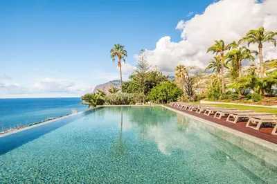a swimming pool with the ocean in the background at Oceans Glow by Homie in Funchal