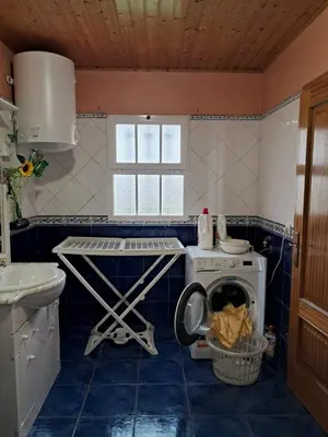 a kitchen with a washing machine and a washer at O Chalé das Borboletas in Santa Maria Madalena