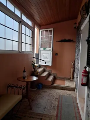a room with stairs and a table and windows at O Chalé das Borboletas in Santa Maria Madalena
