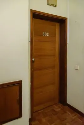 a wooden door with the on it in a room at Casa Branca Apartment by Mth in Funchal