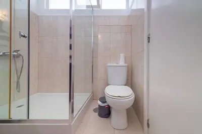 a bathroom with a white toilet and a shower at Casa Branca Apartment by Mth in Funchal