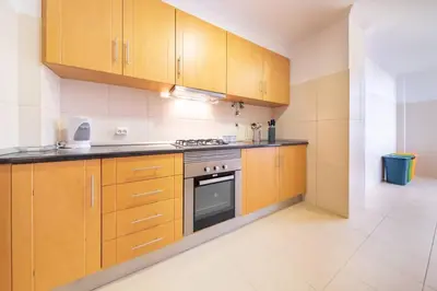 a kitchen with wooden cabinets and a stove at Casa Branca Apartment by Mth in Funchal