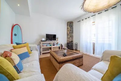 a living room with two couches and a coffee table at Casa do Sol in Bordeira
