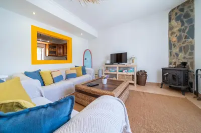 a living room with a couch and a table at Casa do Sol in Bordeira