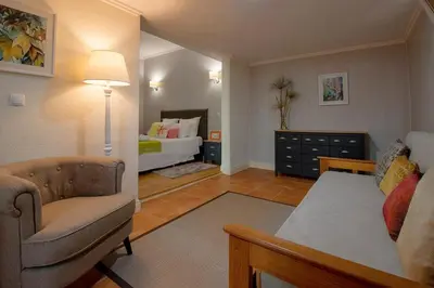 a living room with a couch and a bed at Quinta do Bom Sucesso in Funchal