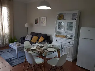 a living room with a table and a couch at Quinta do Bom Sucesso in Funchal