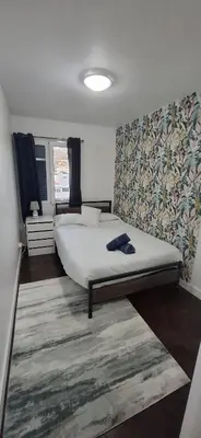 a bedroom with a large bed and a rug at Great Stay 3 Bedroom Funchal Central Retreat in Funchal