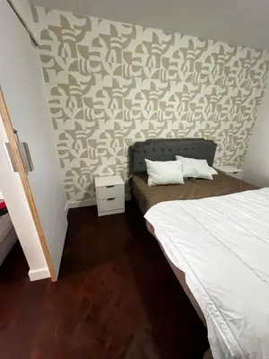 a bedroom with a bed and a wall at Great Stay 3 Bedroom Funchal Central Retreat in Funchal