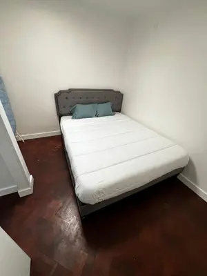 a bed in a small room with a white mattress at Great Stay 3 Bedroom Funchal Central Retreat in Funchal