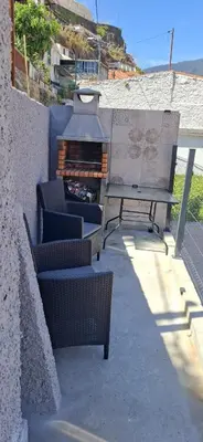 a patio with two chairs and a table and a grill at Great Stay 3 Bedroom Funchal Central Retreat in Funchal