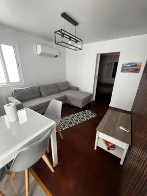 a living room with a couch and a table at Great Stay 3 Bedroom Funchal Central Retreat in Funchal