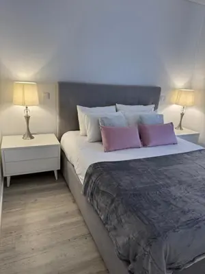 a room with white cabinets and a chandelier at Grota Funchal in Funchal