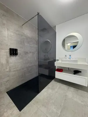 a white bathroom with a sink and a mirror at Grota Funchal in Funchal