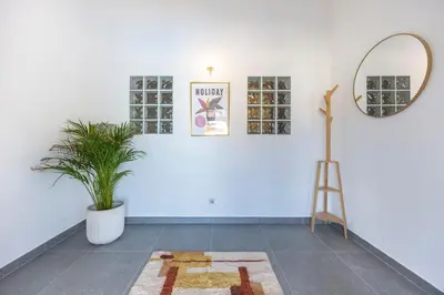 a white room with a potted plant and a mirror at Casa Salácia in Aljezur